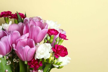 Beautiful bouquet of fresh flowers on a color background