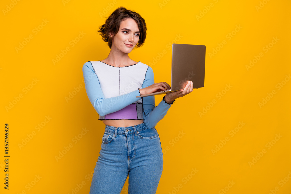 Poster photo of nice positive young lady hold use wireless netbook eshopping isolated on yellow color backg