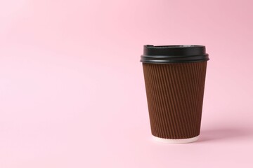 Paper cup with plastic lid on light background. Coffee to go