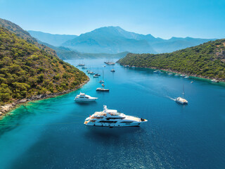 Aerial view of beautiful yachts and boats on the sea at sunset in summer. Gemiler Island in Turkey....