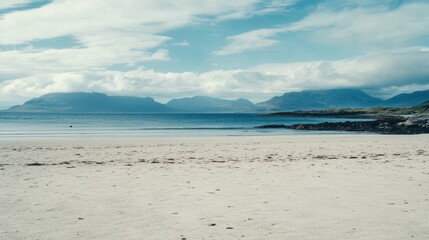 Serene Coastal Landscape: White Sands and Distant Mountains