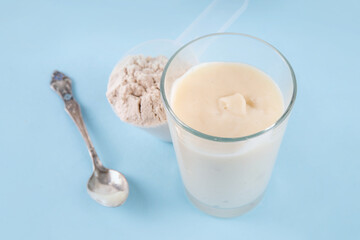 Quick and simple protein pudding. Healthy summer cold dessert. Three glasses with vanilla, chocolate and berry protein pudding, with chocolate slices, fresh strawberry, blueberry, protein powder scoop