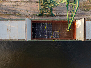 General cargo ship is loaded with metal pipes. Pipes for gas and oil pipeline construction