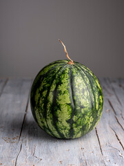 Studio still life of a watermelon on dark background. Vivid colors and controlled lighting highlight texture, freshness, and artistic contrast in a professional studio setting.