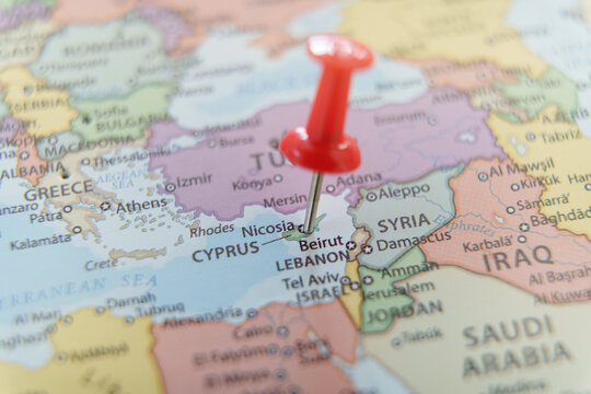 Close-up of a map with a red pushpin marking Cyprus. Travel, geography, and politics concept.