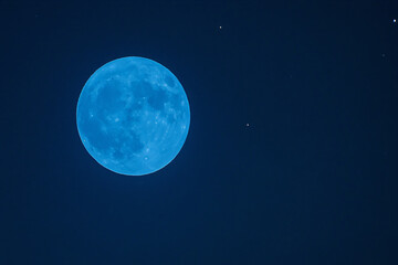 a blue moon with a few stars in the sky