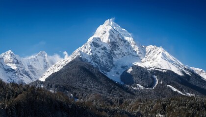 majestic snow capped mountain peak soaring against a clear blue sky