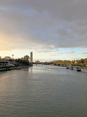Fototapeta premium Guadalquivir river, Sevilla, Spain, whit view of la Torre del Oro and el Puente de Triana. at the sunset 