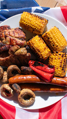 Barbecue platter with grilled corn, sausages, and mushrooms, summer picnic, Independence Day celebration