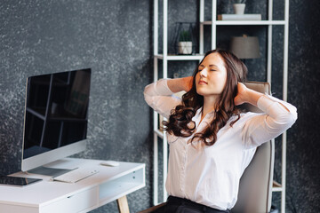 Businesswoman stretching in office chair during work break for relaxation