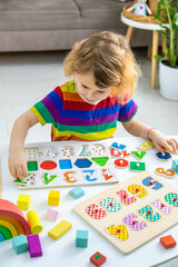 Fototapeta premium Child learns numbers and letters. Selective focus.