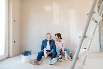 Senior couple renovating their home, a shared retirement activity.