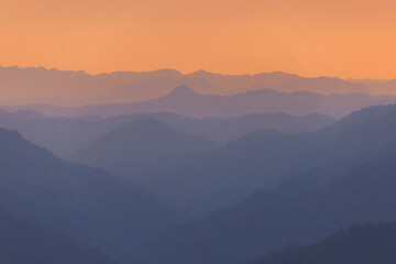 Mountain range with a beautiful orange sky in the background