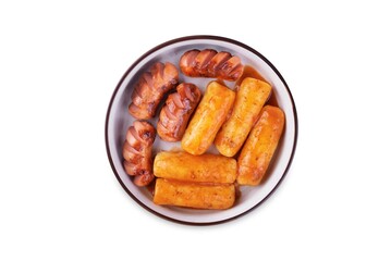 Fried sausages with spicy tomato sauce teokbokki in a bowl on a white isolated background