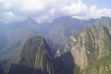 Stunning views over the old historic ruins of Machu Picchu in the Andes Mountains cloud forests of Peru