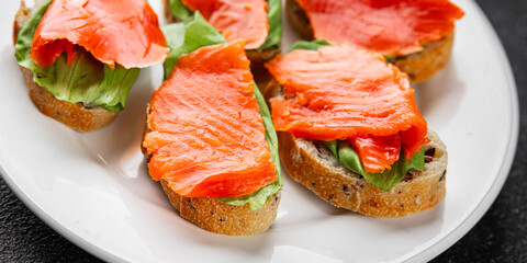 Salmon sandwich red fish seafood appetizer dish fresh tasty gourmet food background on table rustic food top view copy space pescetarian diet