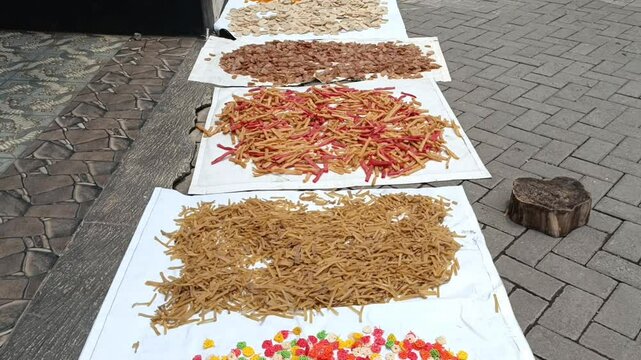 Raw Unfried Crackers Drying on White Trays Under Sunlight for Traditional Food Production
