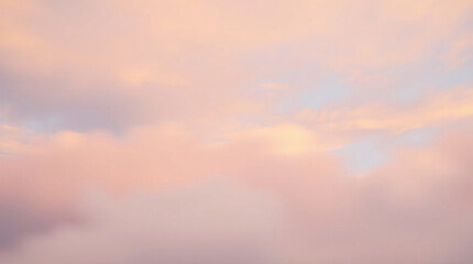 Obraz premium A serene sky with soft pastel clouds at sunset, creating a tranquil and ethereal atmosphere.