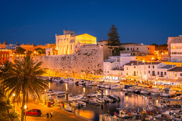 Menorca in Spain. The beautiful port town of Ciutadella after sunset. View of the old town and the picturesque port