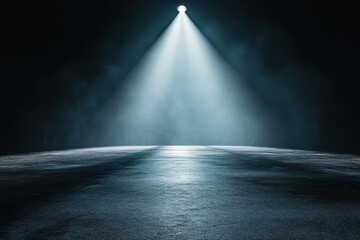 Dramatic spotlight illuminates dark stage floor creating moody atmosphere for performance or presentation