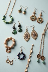 Close-up photo of various recycled jewelry pieces including earrings, necklaces, and bracelets laid out on a light grey background,  ethical,  minimalist