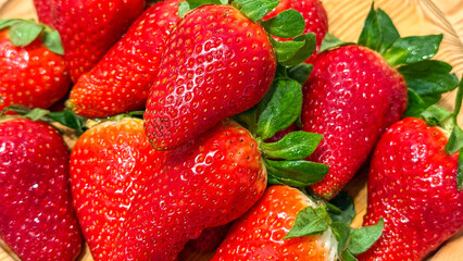 Fresh ripe strawberries on wooden background, summer harvest, sweet juicy fruit, healthy eating