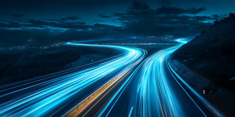 Obraz premium Nighttime highway with vibrant light trails in a mountainous landscape