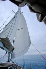 Sailing in the English Channel with full sails up on a small yacht on a calm day