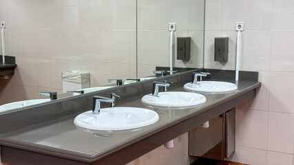 Clean public restroom interior with modern sinks and mirrors, hygiene, contemporary design, sanitation focus