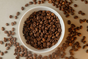 Freshly roasted coffee beans arranged beautifully in a white bowl