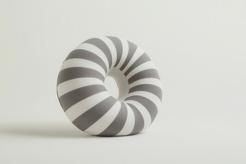 Obraz premium A minimalist, striped cushion in gray and white, designed in a circular shape, emphasizing modern decor aesthetics.