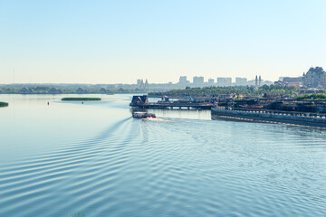 A pleasure boat floats on the calm waters of the Kazanka River against the backdrop of the...
