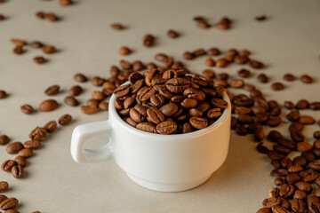 Coffee beans overflowing from a white cup create a cozy coffee moment