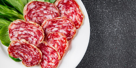 Dry-cured sausage salami appetizer dish fresh delicious gourmet food background on the table rustic...