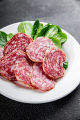 Dry-cured sausage salami appetizer dish fresh delicious gourmet food background on the table rustic food top view copy space