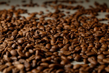Artful arrangement of roasted coffee beans across a textured surface