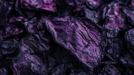 Obraz premium A macro shot of dried blueberries, their deep purple surfaces showing intricate wrinkled textures