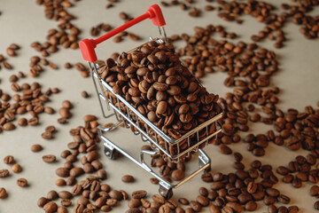 Shopping cart filled with roasted coffee beans on scattered beans