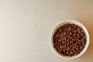 Coffee beans resting in a white bowl ready for brewing in a cozy kitchen