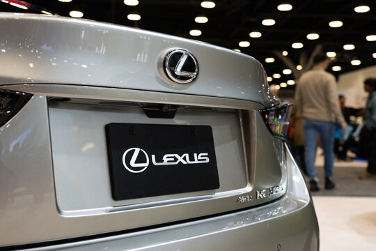 Close-up of Lexus logo badge and license plate on a Lexus IS trunk
