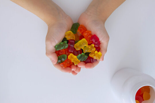 The boy eats jelly beans or takes vitamins