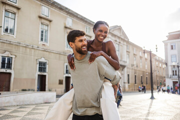 Happy tourist couple piggybacking in lisbon, portugal, europe © PintoArt
