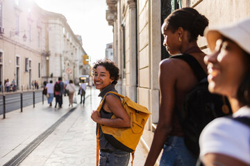 Young tourists exploring city street during summer vacation