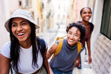 Happy tourists walking and laughing in european city