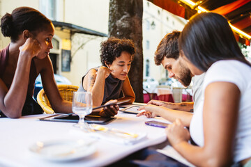 Business people working with digital tablet and smartphone at restaurant table