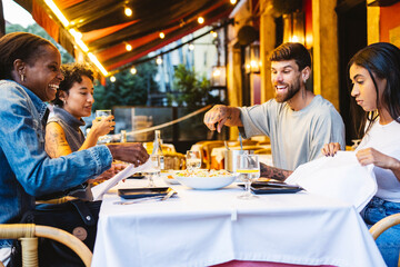 Friends enjoying dinner together at outdoor restaurant