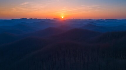 Fototapeta premium Sunrise over Misty Mountain Range