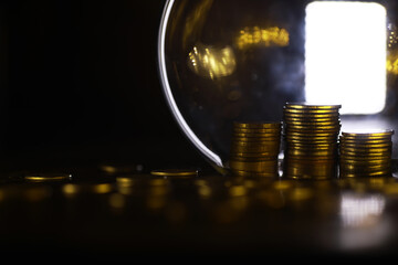 Golden Stacks of Coins by Reflective Surface in Dark Ambient Lighting Highlighting Wealth and Investment Concepts
