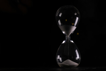 Hourglass on Dark Background - Concept of Time Management, Patience, and Deadline Pressure