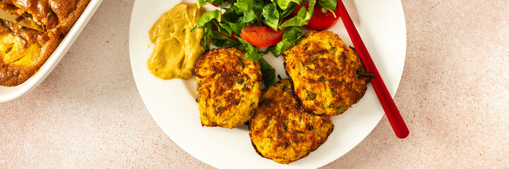 This nutritious breakfast features savory zucchini pancakes with fresh lettuce and tomatoes, paired...